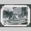 Photo of children on a playground merry-go-round (ddr-densho-483-921)