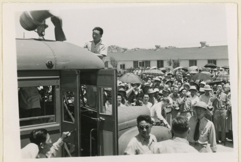Men climb onto buses (ddr-densho-37-1443)