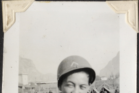 Man in helmet with tents in background (ddr-densho-466-704)