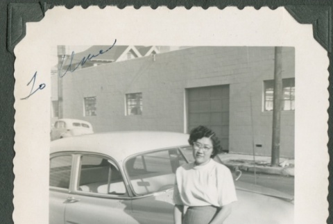 Woman leaning against a car (ddr-densho-328-224)