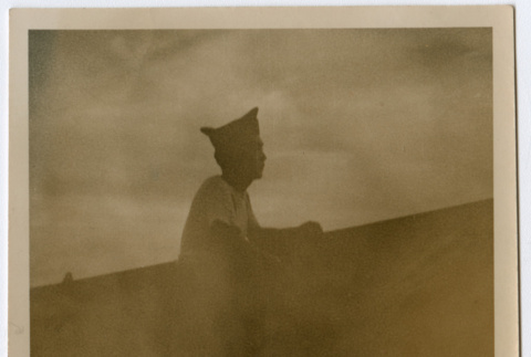 Soldier aboard ship looking out over water (ddr-densho-368-36)