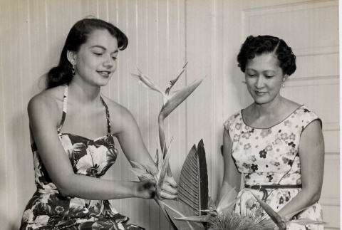 Two women creating flower arrangement (ddr-njpa-2-993)