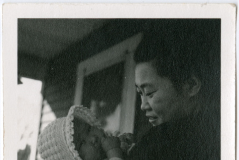 Tokuko Kishi holding baby on porch (ddr-densho-329-781)