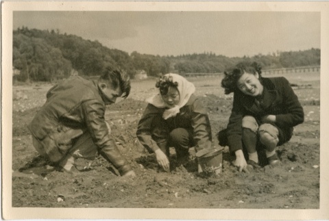 Man and two women digging in dirt (ddr-densho-201-435)