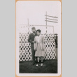 Joe and June (Kuramoto) Kumagai standing by lattice fence (ddr-densho-493-50)