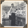 Man shopping at The Owl Drug Co. (ddr-densho-542-114)