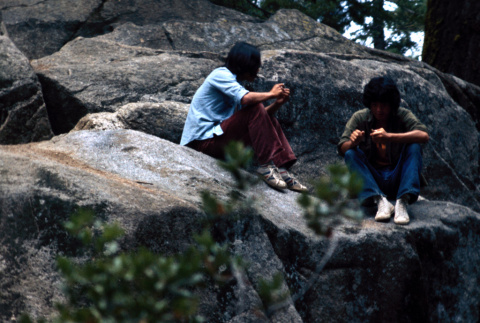 Campers sitting on boulders (ddr-densho-336-357)