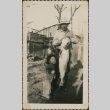Man with large fish and small girl (ddr-densho-321-279)