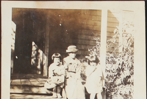 A woman and two girls on a porch (ddr-densho-278-231)