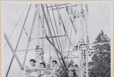 Three children on Ferris wheel (ddr-densho-522-328)