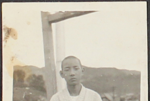 A teenage boy posing on a deck (ddr-densho-278-57)