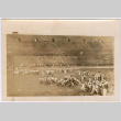 Large group wrestling on field in stadium (ddr-densho-329-1370)