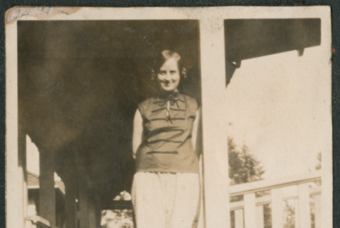 Woman standing  on porch (ddr-densho-523-11)