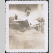 Man laying on bunk reading (ddr-densho-434-473)
