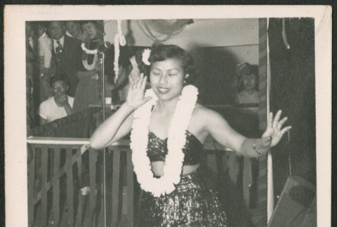 Woman dancing in skirt and lei (ddr-densho-293-169)