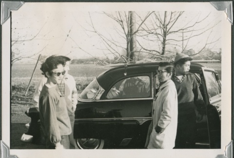 Group standing outside a car (ddr-densho-321-464)