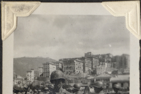 Man with rifle with other soldiers in background (ddr-densho-466-767)