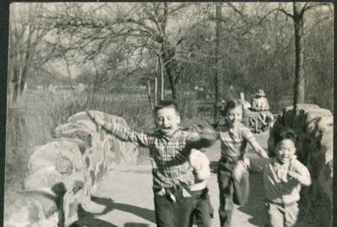 Children running across stone bridge (ddr-densho-523-252)