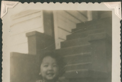 Girl sitting on stairs (ddr-densho-321-1053)