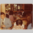 Four people sitting at a table, two people at a table in foreground (ddr-densho-426-1326)