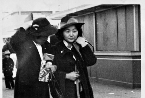 Pair walking in dark coats (ddr-densho-1007-56)