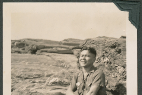 Photo of man sitting on rock (ddr-densho-483-374)