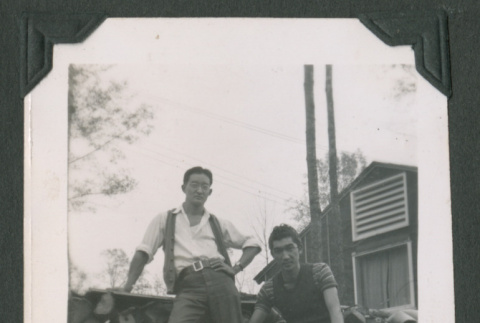 Two men on log pile (ddr-densho-471-55)