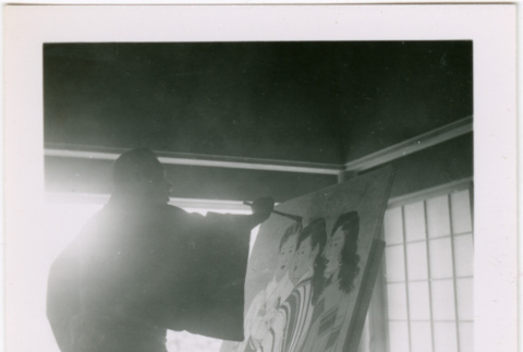 Man painting large canvas (ddr-densho-426-2459)