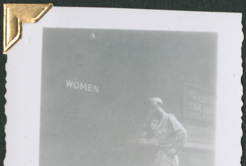 Man standing by sign that says 