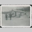 Men with skis standing outside a house (ddr-densho-321-345)