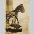 Toy stuffed horse and kitten sleeping in basket (ddr-densho-423-536)