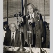 Ingram Stainback seated next to man speaking into microphones (ddr-njpa-2-1194)