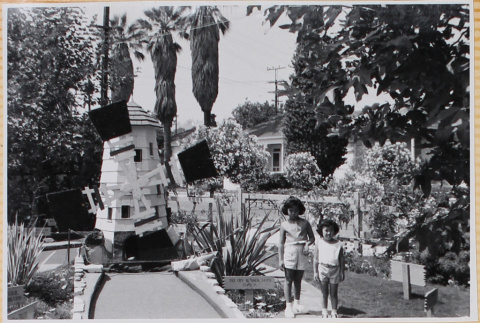 Susan and Leslie Shiomi by miniature golf course (ddr-densho-522-592)
