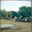 Men working on landscaping at D. Hill Nursery near Torii gate (ddr-densho-377-1437)