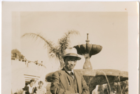 Unidentified man standing by fountain (ddr-densho-423-485)
