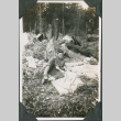 Man lying in forest near tents (ddr-ajah-2-253)