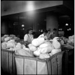 Three people packing items for shipping (ddr-densho-426-946)