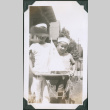 Photo of two children with a toy boat (ddr-densho-483-1210)
