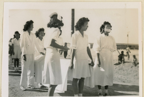 Nurses carrying a stretcher in an Armistice Day parade (ddr-densho-37-1174)