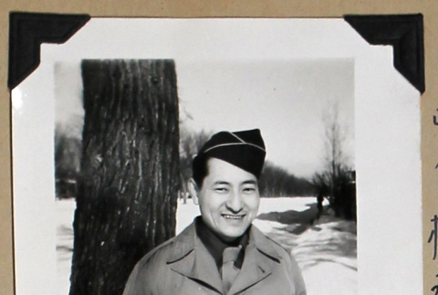 Smiling man in military uniform (ddr-densho-404-374)