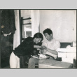 Couple looking at gifts (ddr-densho-523-530)