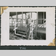 Man standing on stairs outside building (ddr-densho-434-231)