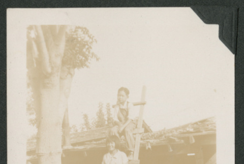 boy and girl sitting on ladder (ddr-densho-378-671)