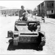 Nisei soldier sitting on a tank (ddr-densho-34-50)