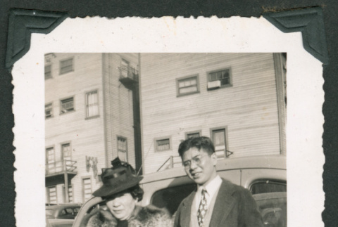 Photo of a man and a woman beside a car (ddr-densho-483-357)