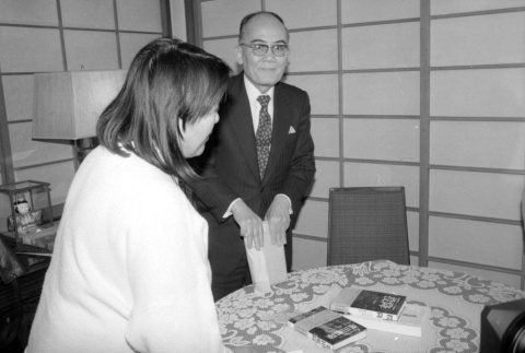 Loni Ding and Kiyofumi Kojima at table (ddr-densho-1007-578)