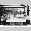 Group of men with young boy sitting at a table (ddr-ajah-6-584)