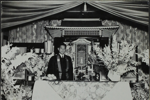Rev. Kumata at a Buddhist altar (ddr-densho-328-536)