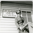 Tom Kubota in uniform in front of 3rd Platoon Co. C 27th Battalion sign (ddr-densho-354-1997)