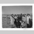 Japanese Americans next to camp fence (ddr-densho-157-28)